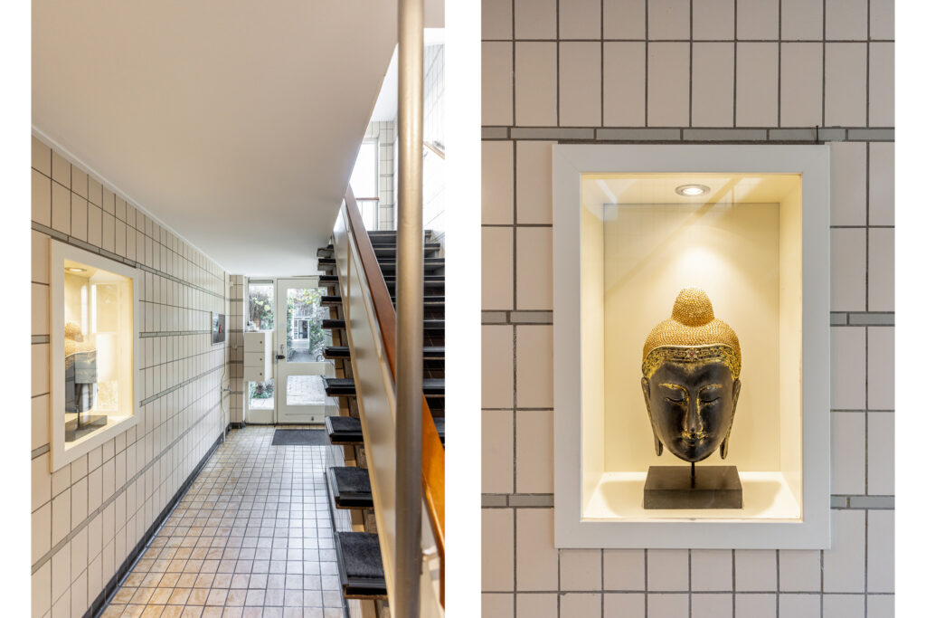 Modern hallway with Buddha head display.