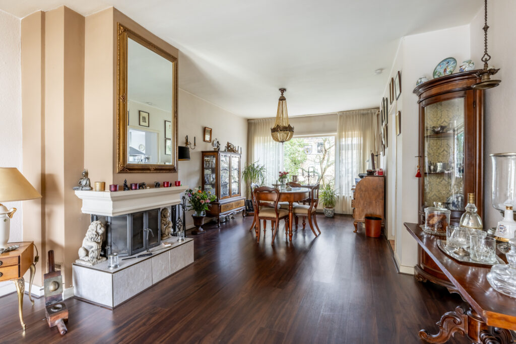 Elegant dining room with chandelier and fireplace.