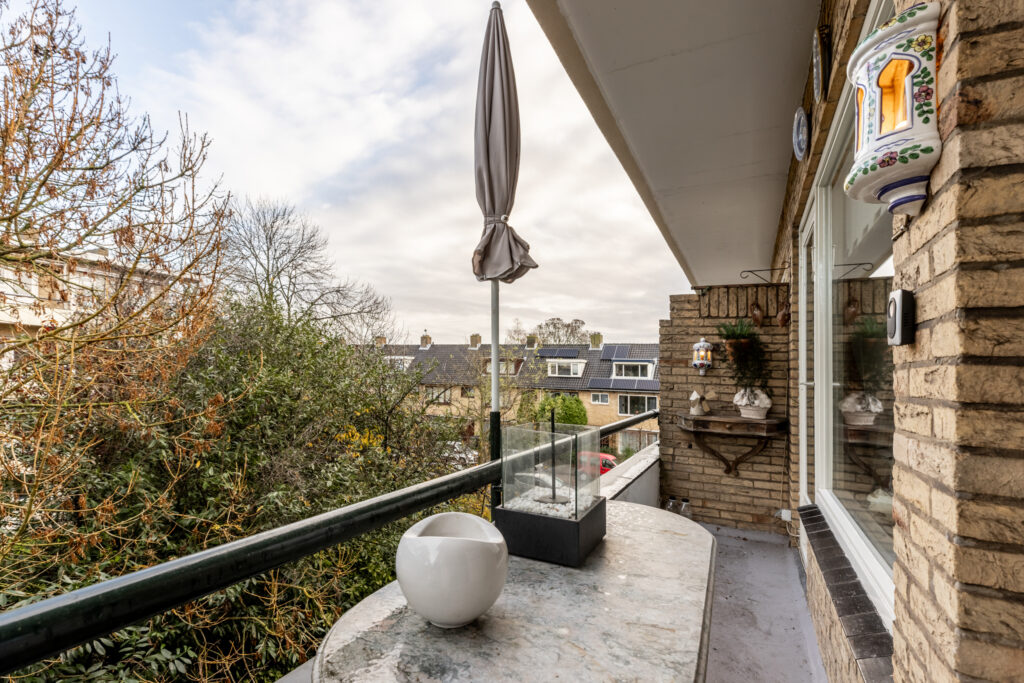 Balcony with trees and rooftops view.