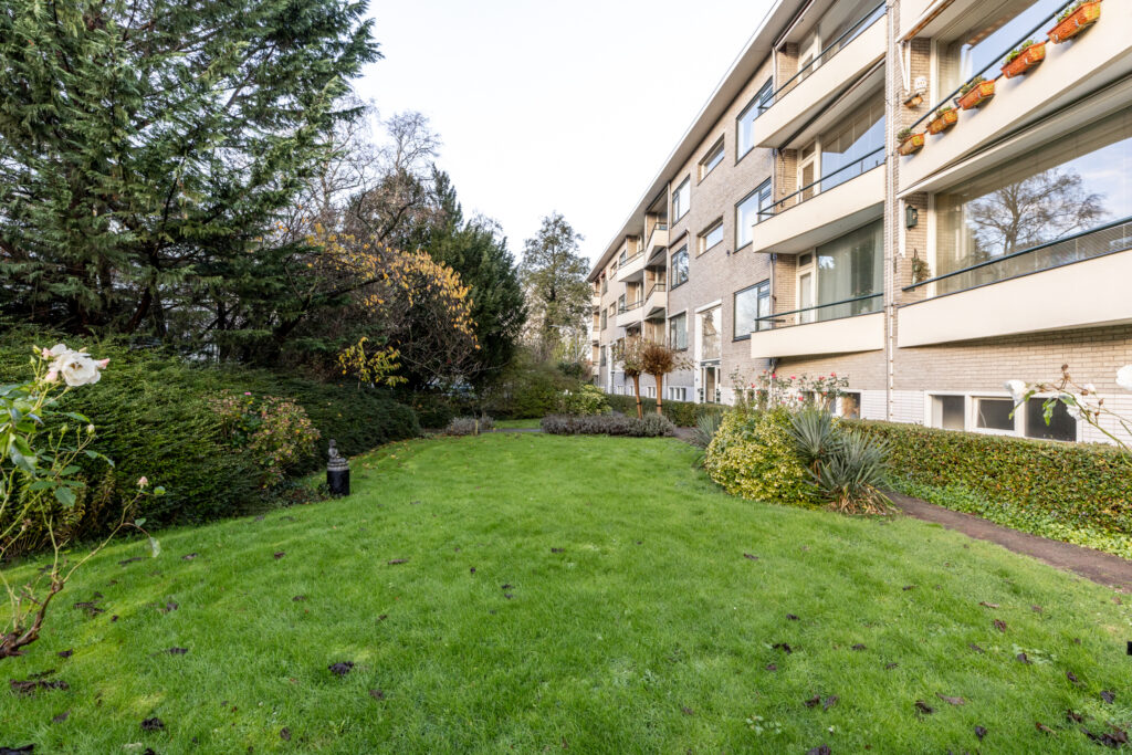 Apartment building with garden and trees
