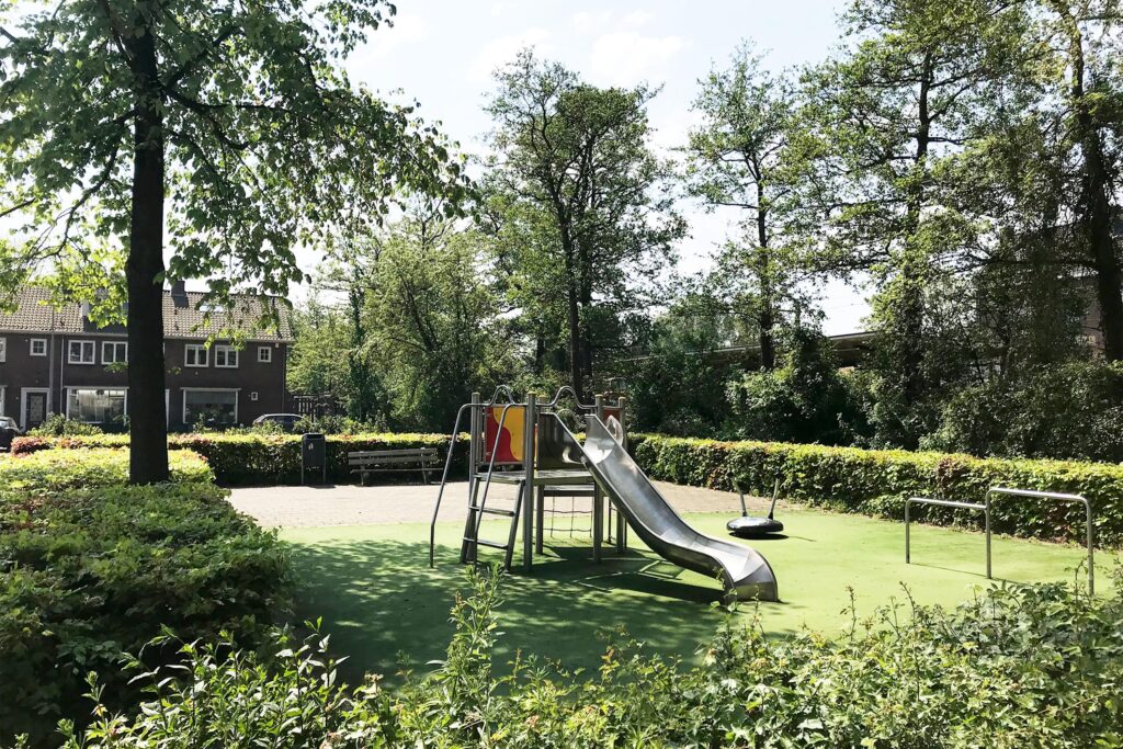 Sunny park with slide and playground.