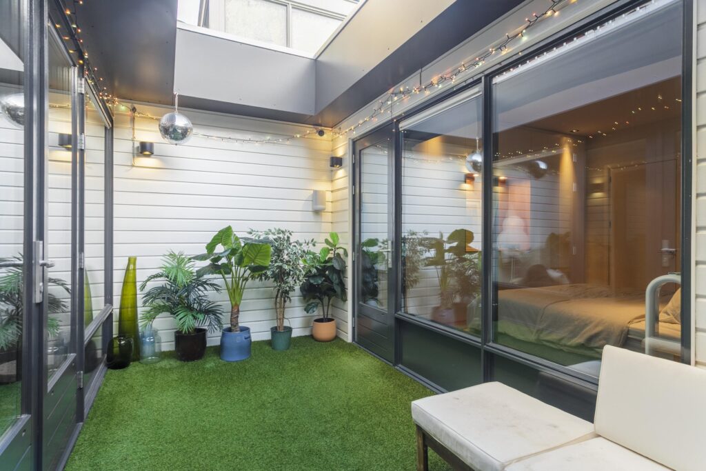 Indoor garden with plants and artificial grass