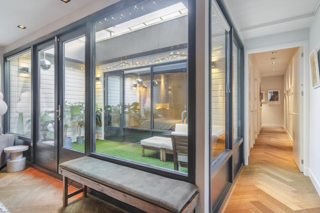 Modern interior with glass doors and wooden floor