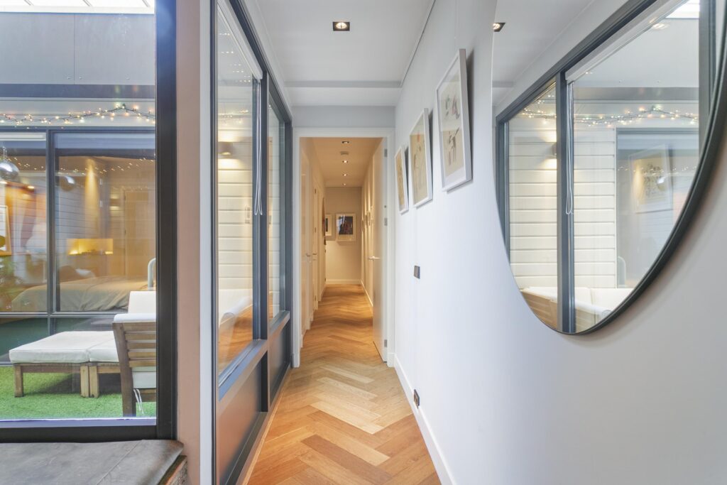 Modern hallway reflection with wooden flooring