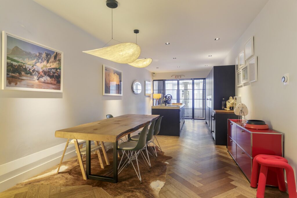 Modern dining room with wood table and art.