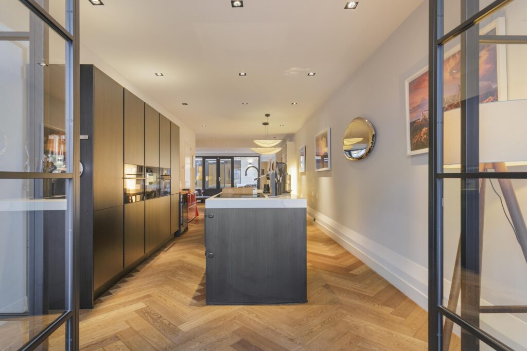 Modern kitchen with wooden herringbone flooring