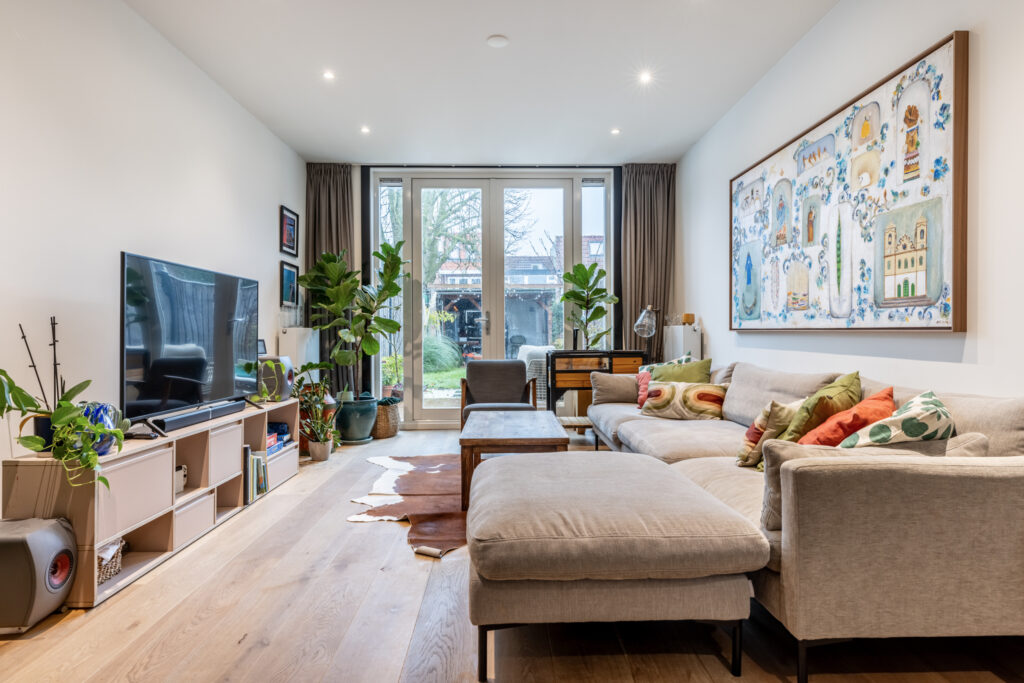 Cozy living room with plants and modern decor.