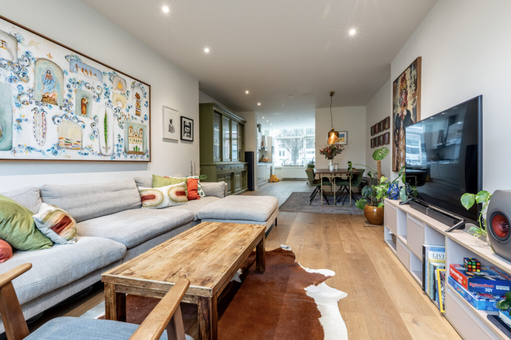 Modern living room with large sofa and art.