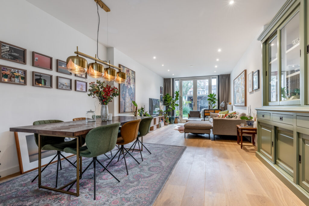 Modern open living and dining room with decor.