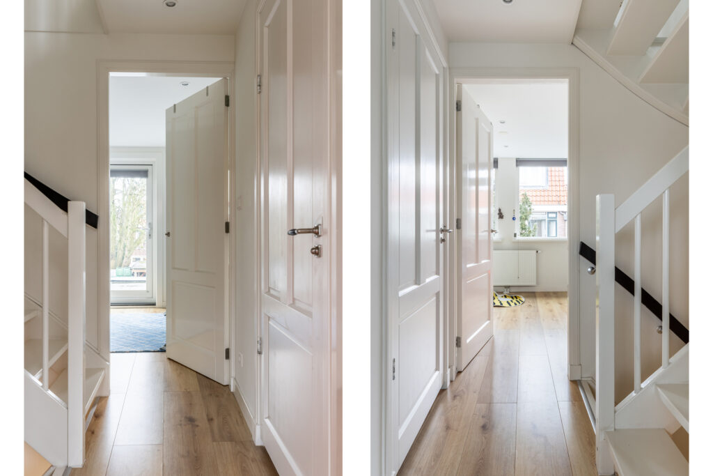 Modern hallway with wooden floors and white doors.