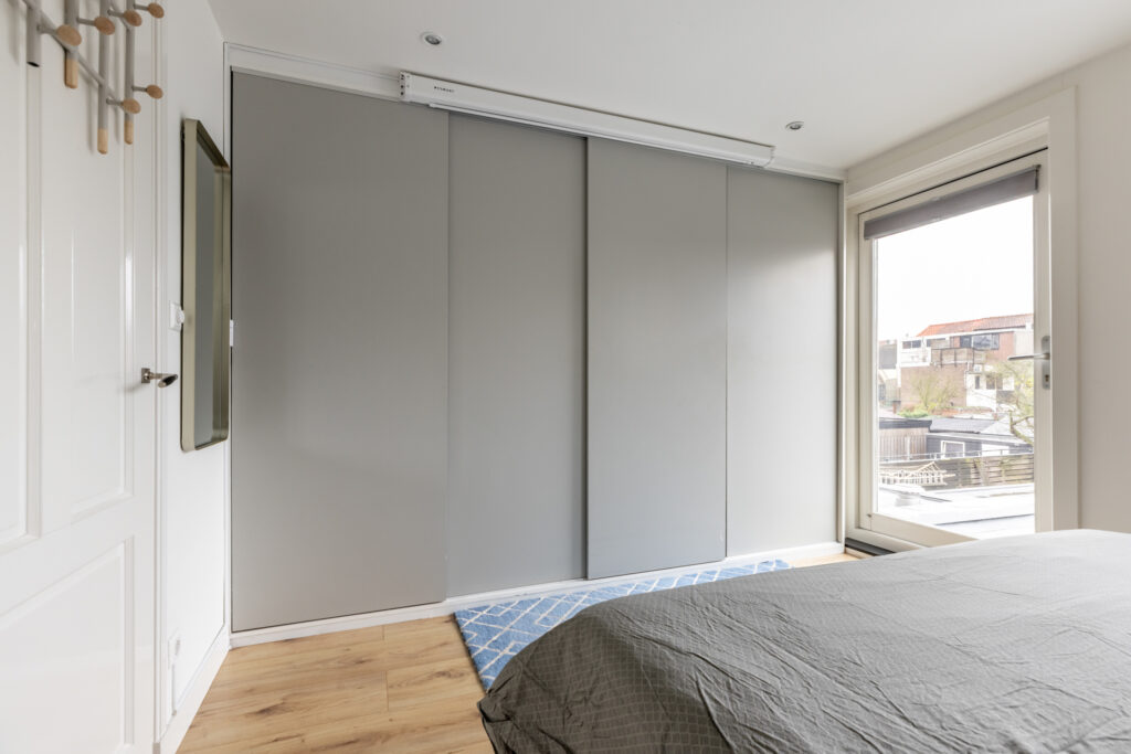 Modern bedroom with sliding closet doors and window