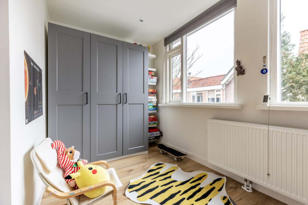 Cozy kids' room with toys and wardrobe.