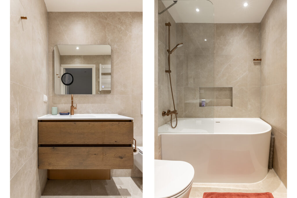 Modern bathroom with wooden vanity and white bathtub.