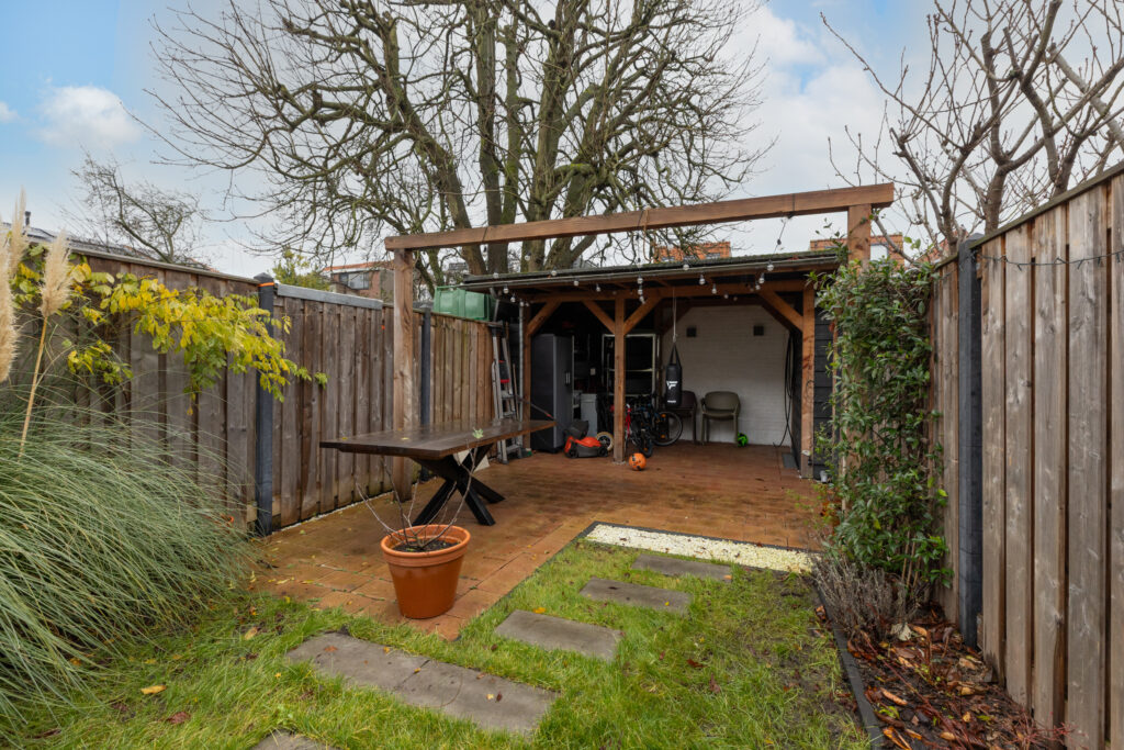 Backyard with wooden shed and patio area