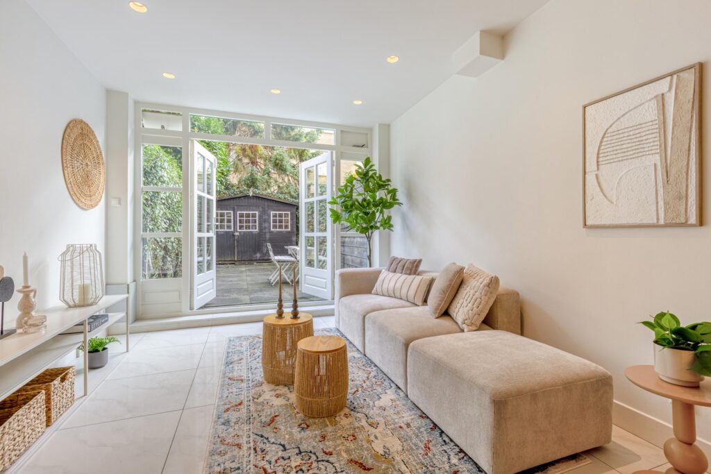 Cozy living room with patio view and greenery.