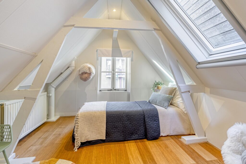 Cozy attic bedroom with skylight and modern decor.