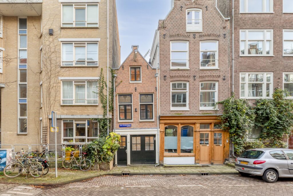 Historic narrow brick building on a city street.
