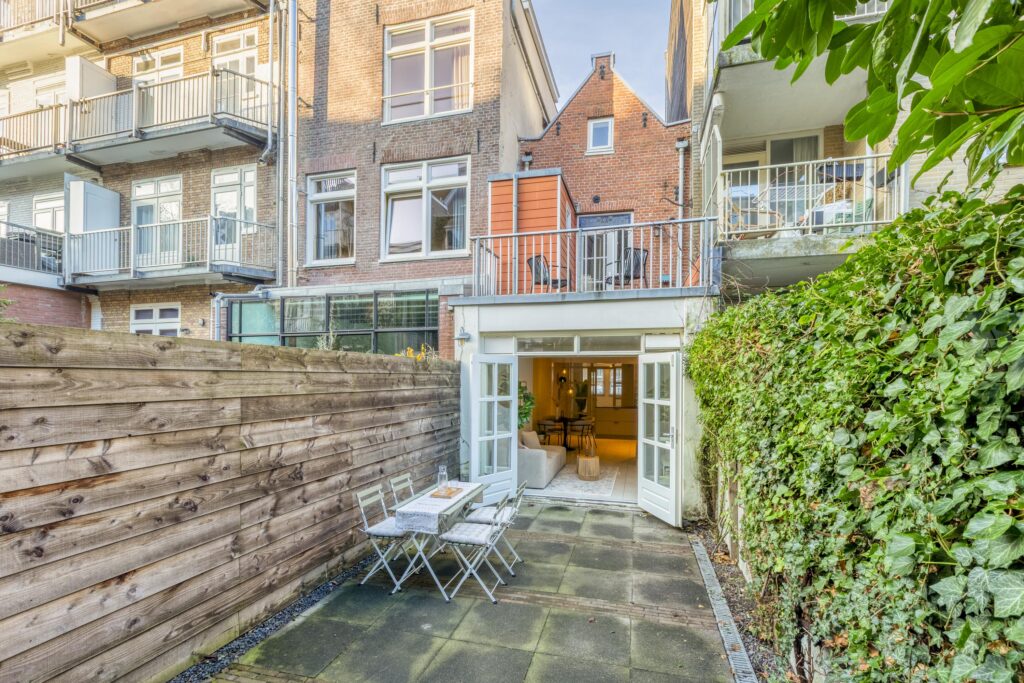 Charming patio with outdoor seating and open doors.