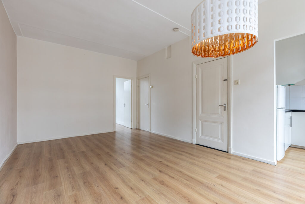 Empty room with wooden floor and modern light.