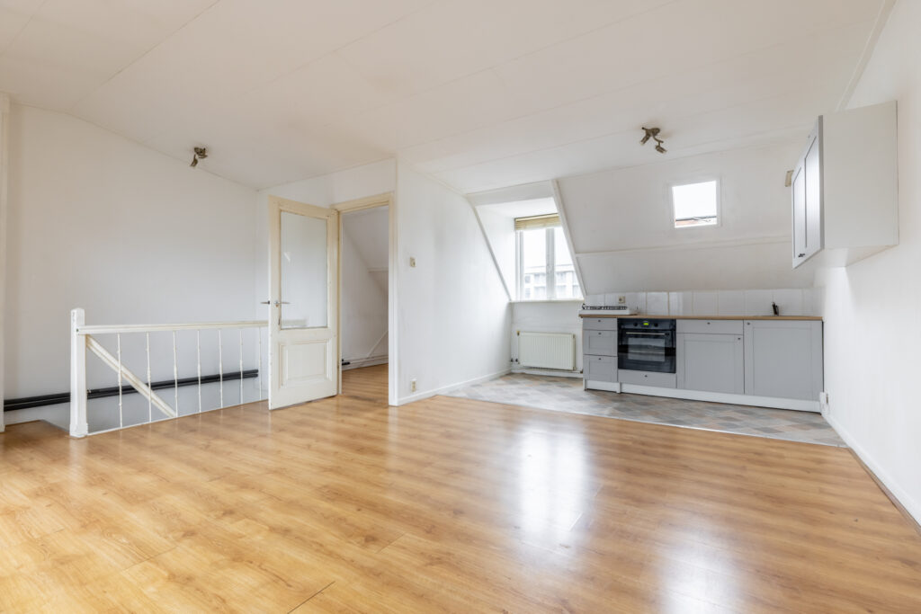 Spacious empty attic apartment with kitchen.