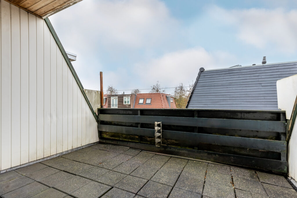 Rooftop terrace with tiled floor and city view.