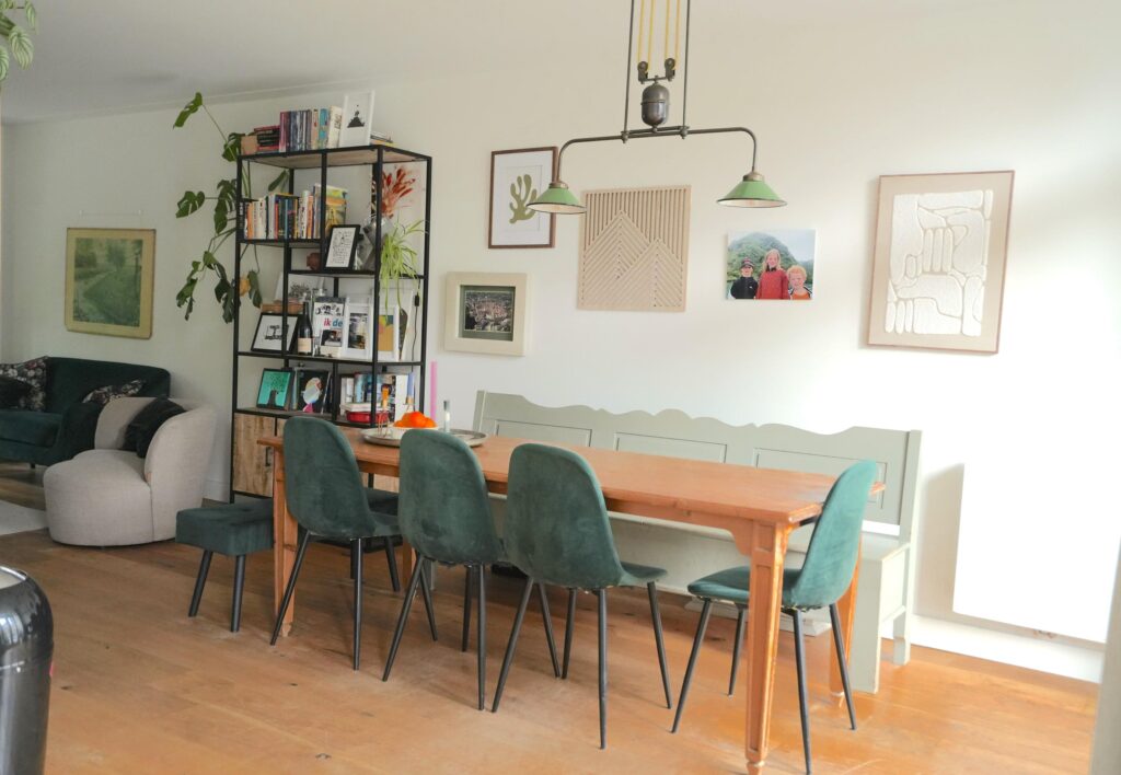 Cozy dining area with bookshelf and artwork.