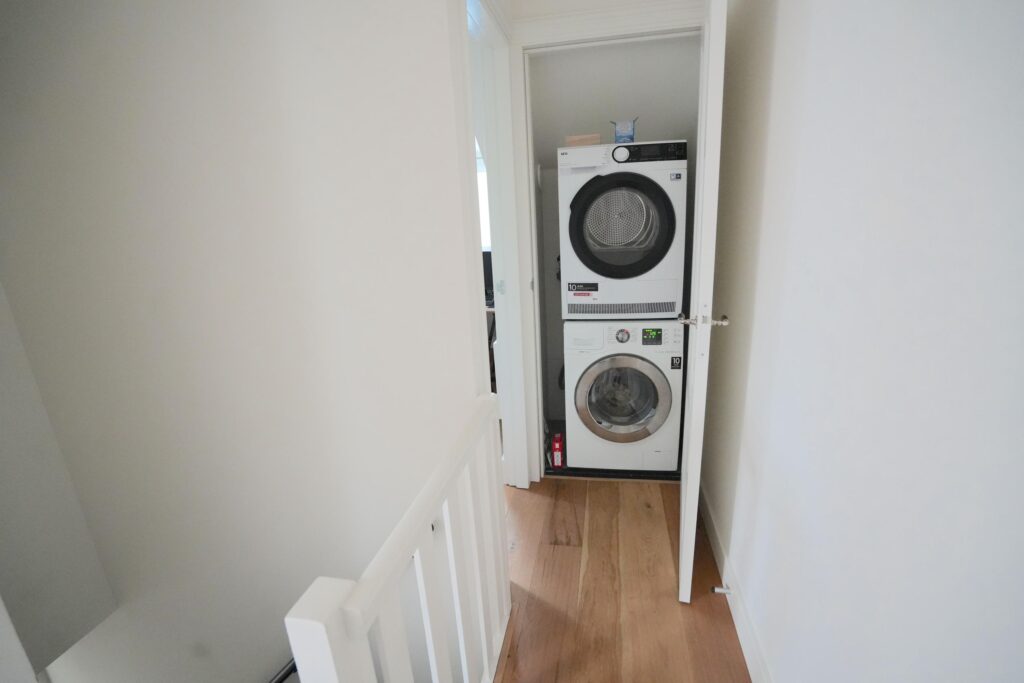 Stacked washer dryer in small laundry closet