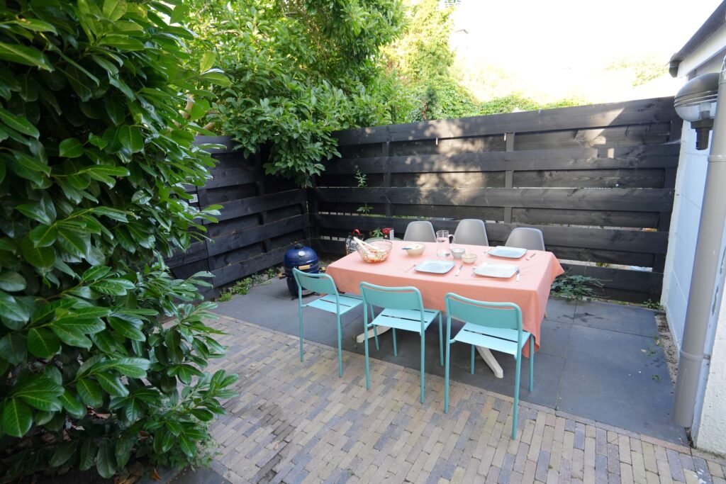Outdoor dining area with table and chairs.